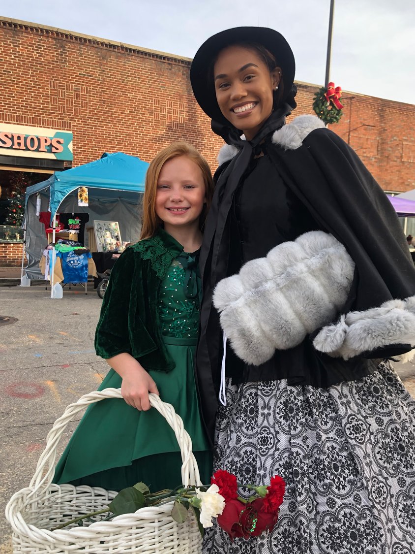 Miss Fayetteville Dogwood Festival Jiniya Pipkin congratulates one of the successful flower salesgirls.