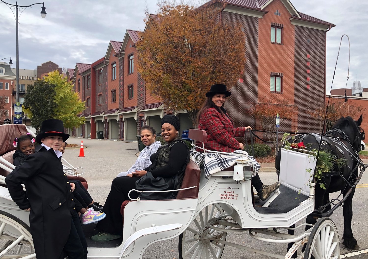 Carriage rides, sponsored by Cool Spring Downtown District, were sold out two weeks in advance. Scouts from Troop 747, like this young man, were able coachman’s assistants.