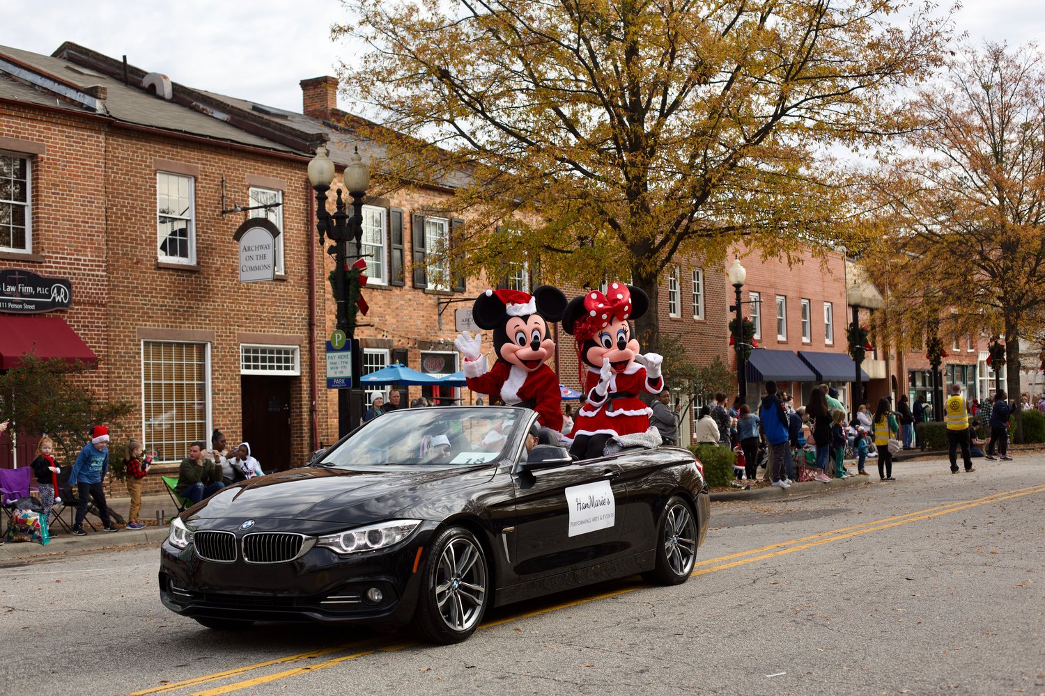 Mickey and Minnie Clause wave to the crowd.