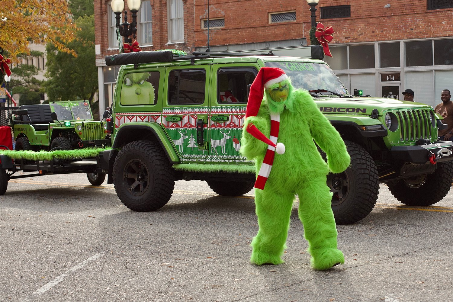The Grinch walks along the parade route.