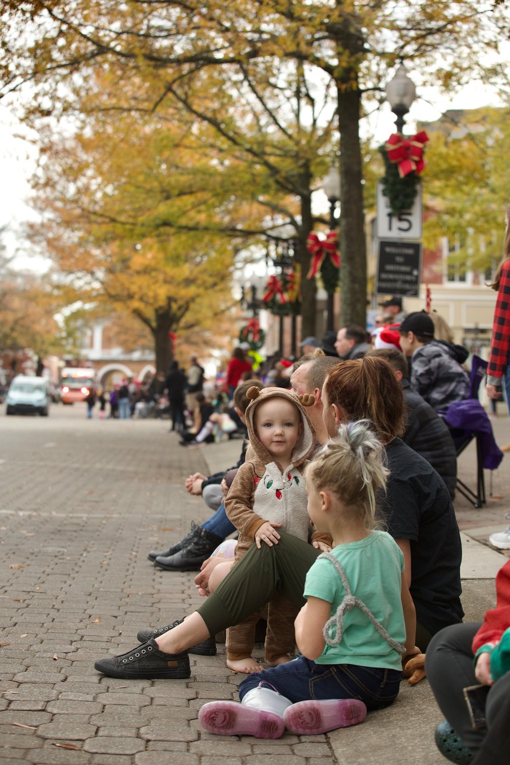 People watch as the Fayetteville Rotary Christmas Parade makes its way through downtown Fayetteville on Saturday.