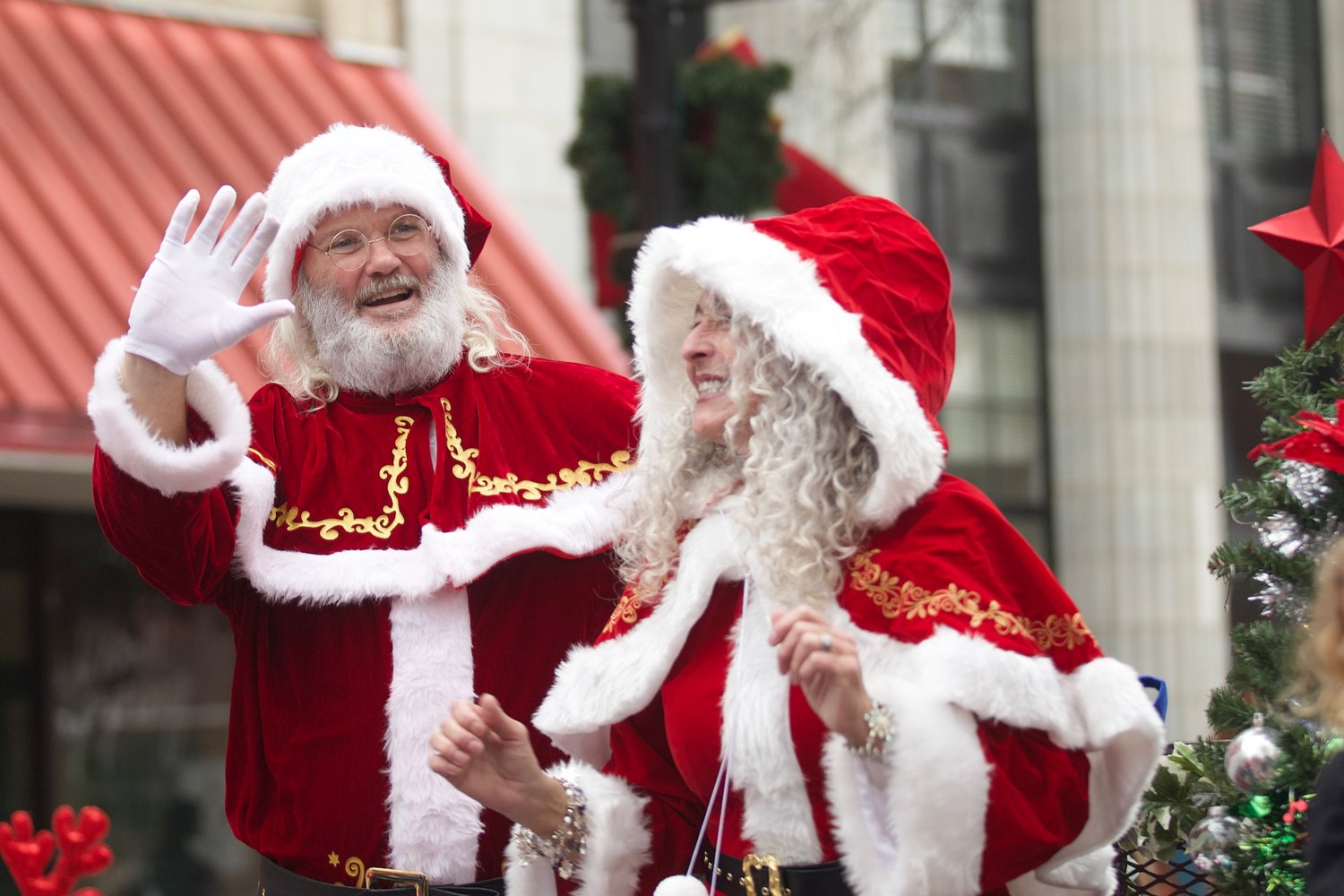 Santa and Mrs. Clause wave to the crowd during the Fayetteville Rotary Christmas Parade on Saturday.