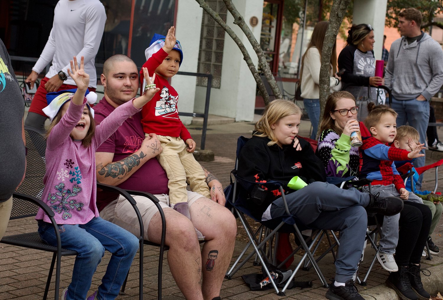 People watch as the Fayetteville Rotary Christmas Parade makes its way through downtown Fayetteville on Saturday.