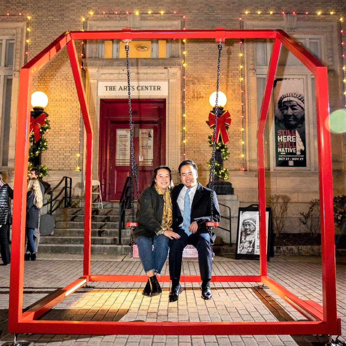 A couple take a swing on one of the 'Mi Casa, Your Casa 2.0' metal frames in front of the Arts Council headquarters on Hay Street.