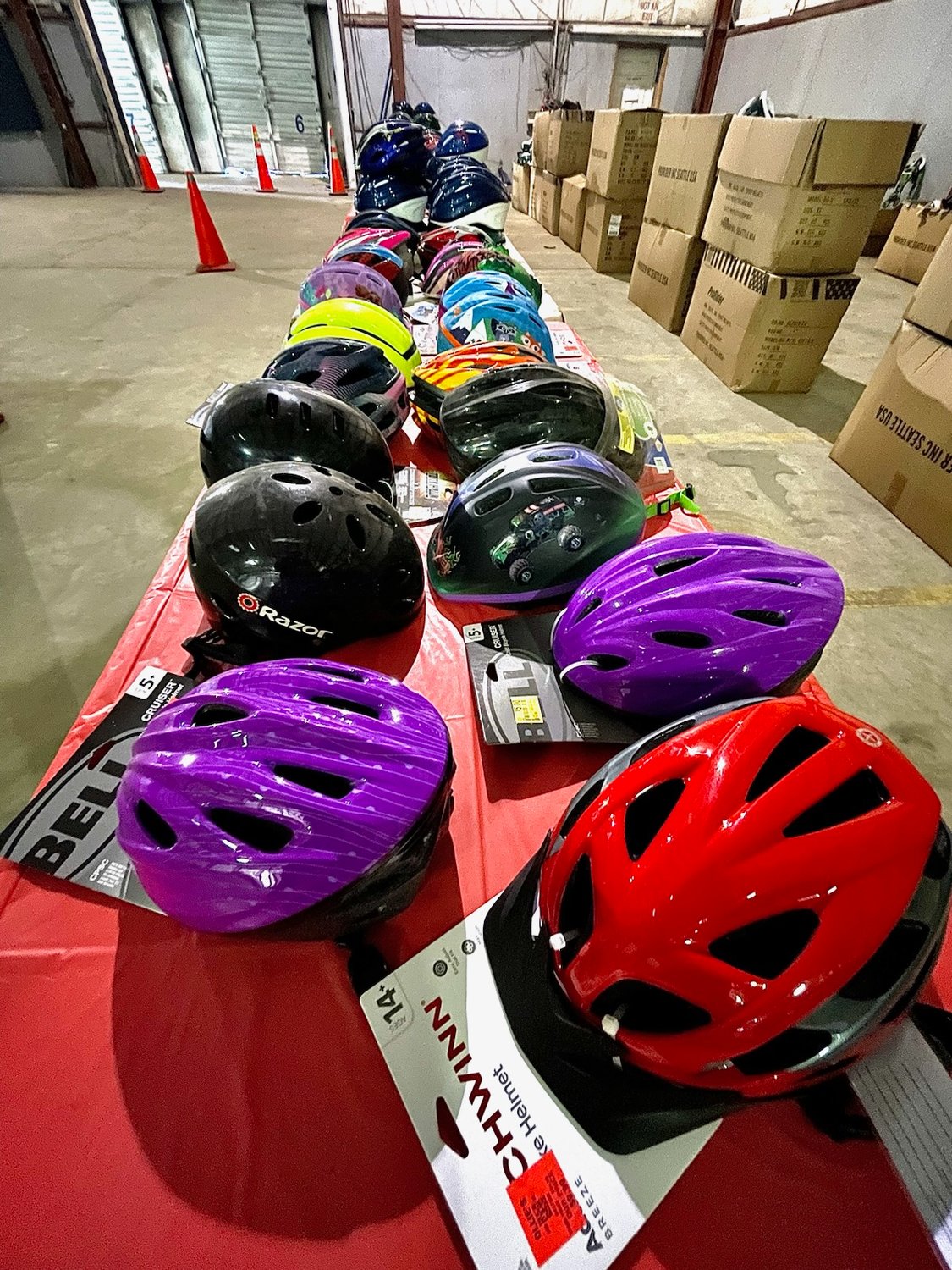 Donated bike helmets line a table.