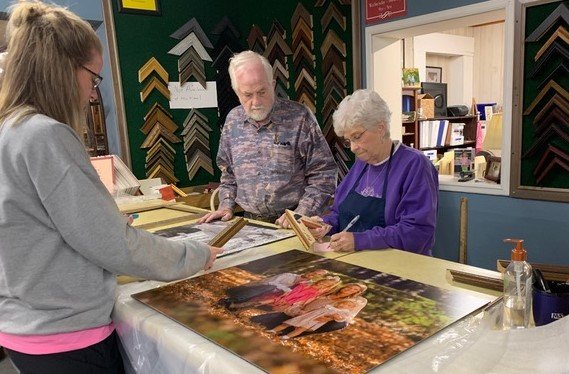 Charles and Shirley McLaurin assist Stephanie Honeycutt with a frame selection at Eastover Art Works.