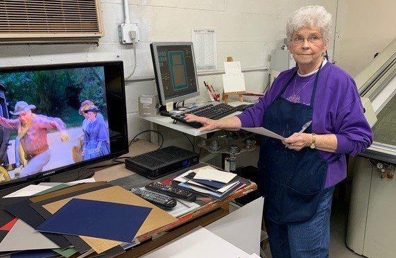 Shirley McLaurin works on a frame order at Eastover Art Works, which is closing after 51 years in business in Eastover.