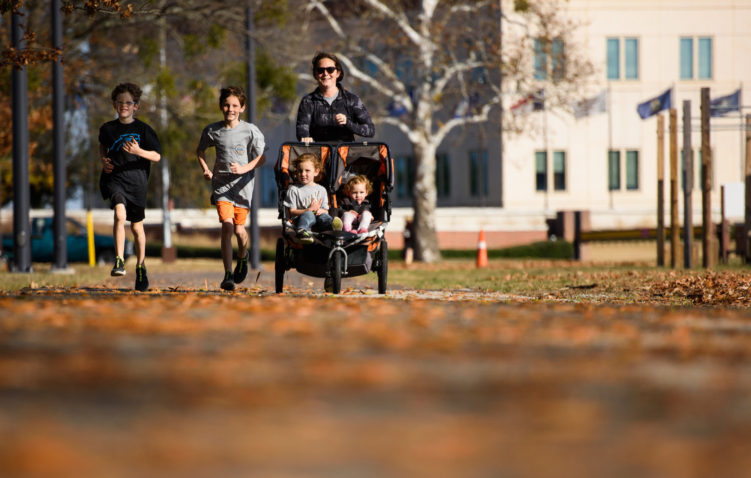 Kelsey Payne, far right, runs with her children, Finn, 10; Owen, 8; Arlo, 4; and Nora, 2; at Pope Field on Fort Bragg. She has run at least one mile every day for more than a year.