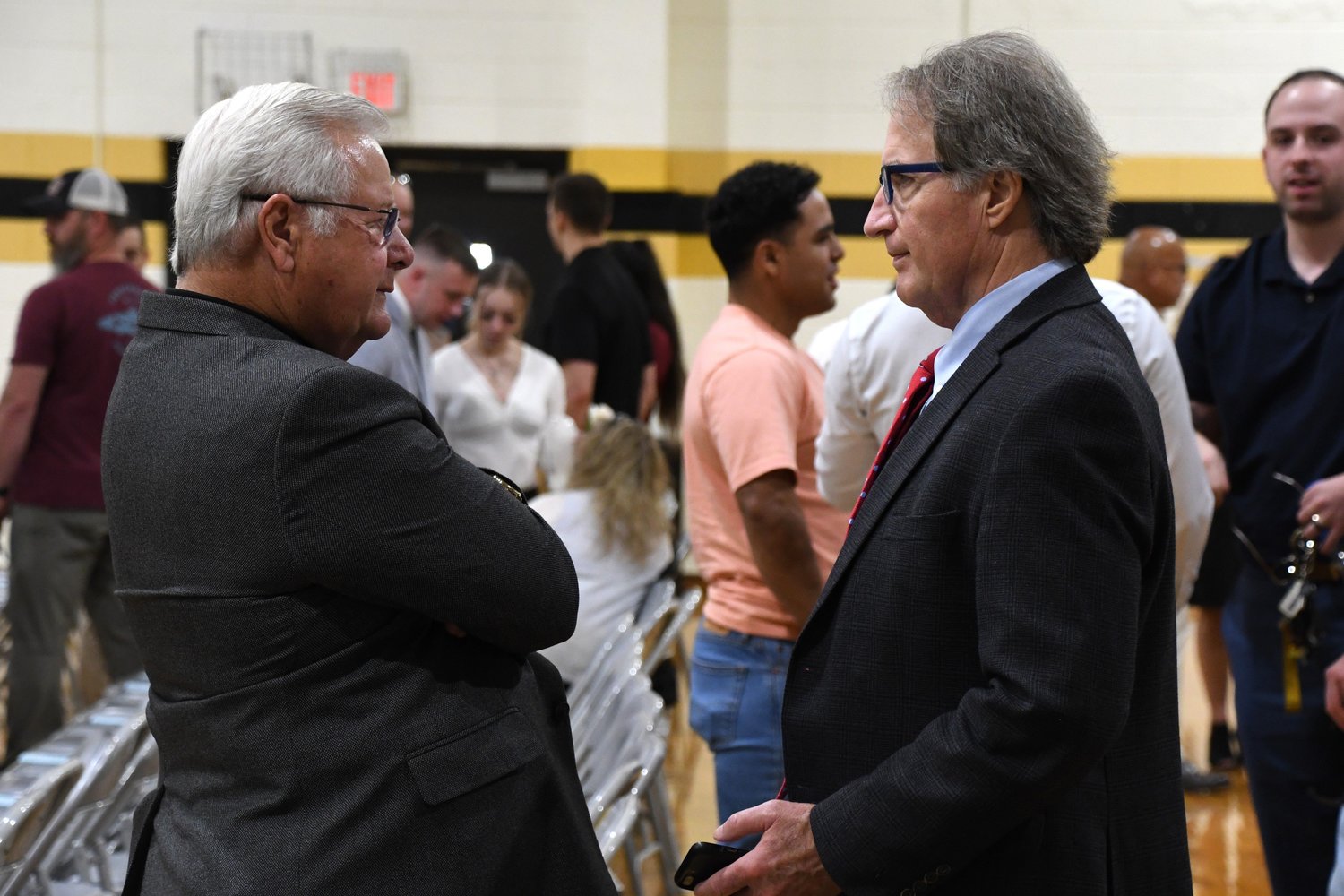 Larry Keen, the outgoing president of Fayetteville Tech, talks with his successor, Mark Sorrells, after Fall Convocation In August.