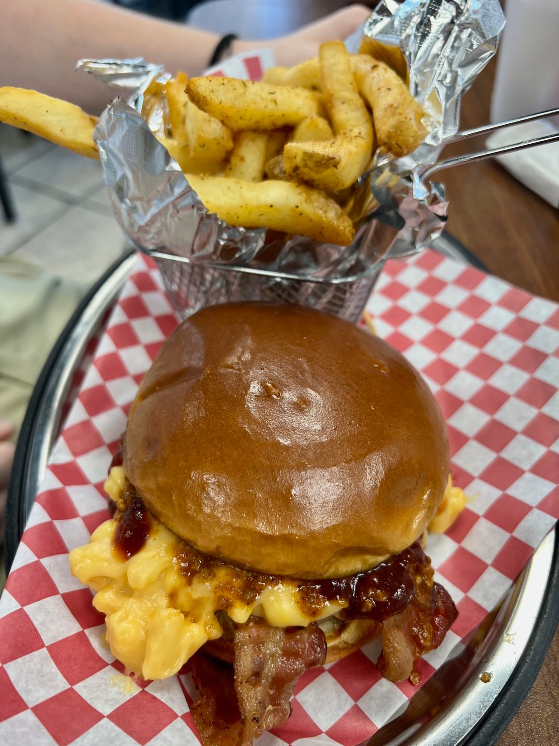 Creative burgers include one that’s stuffed with bacon, chili, mac and cheese and barbecue sauce, at Fry Daddys.