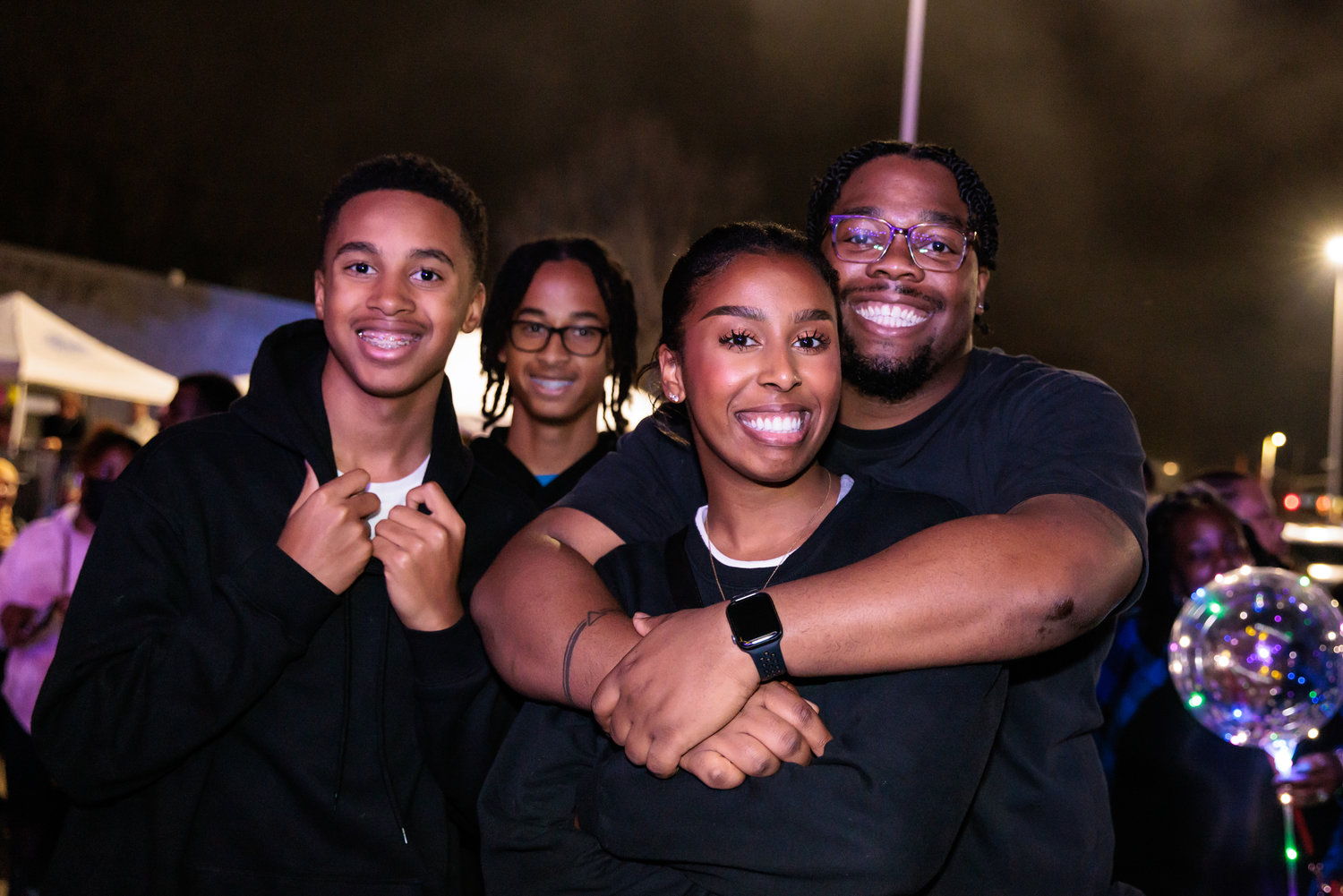 From left, Christopher Wooten, Michael Wooten, Jasmine Wooten, and Reginald Pulley celebrate at “Night Circus.”