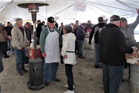 A big tent provides cover for the 2022 Massey Hill Lions Club annual oyster roast. This year, it is anticipated to draw a gathering of more than 500.