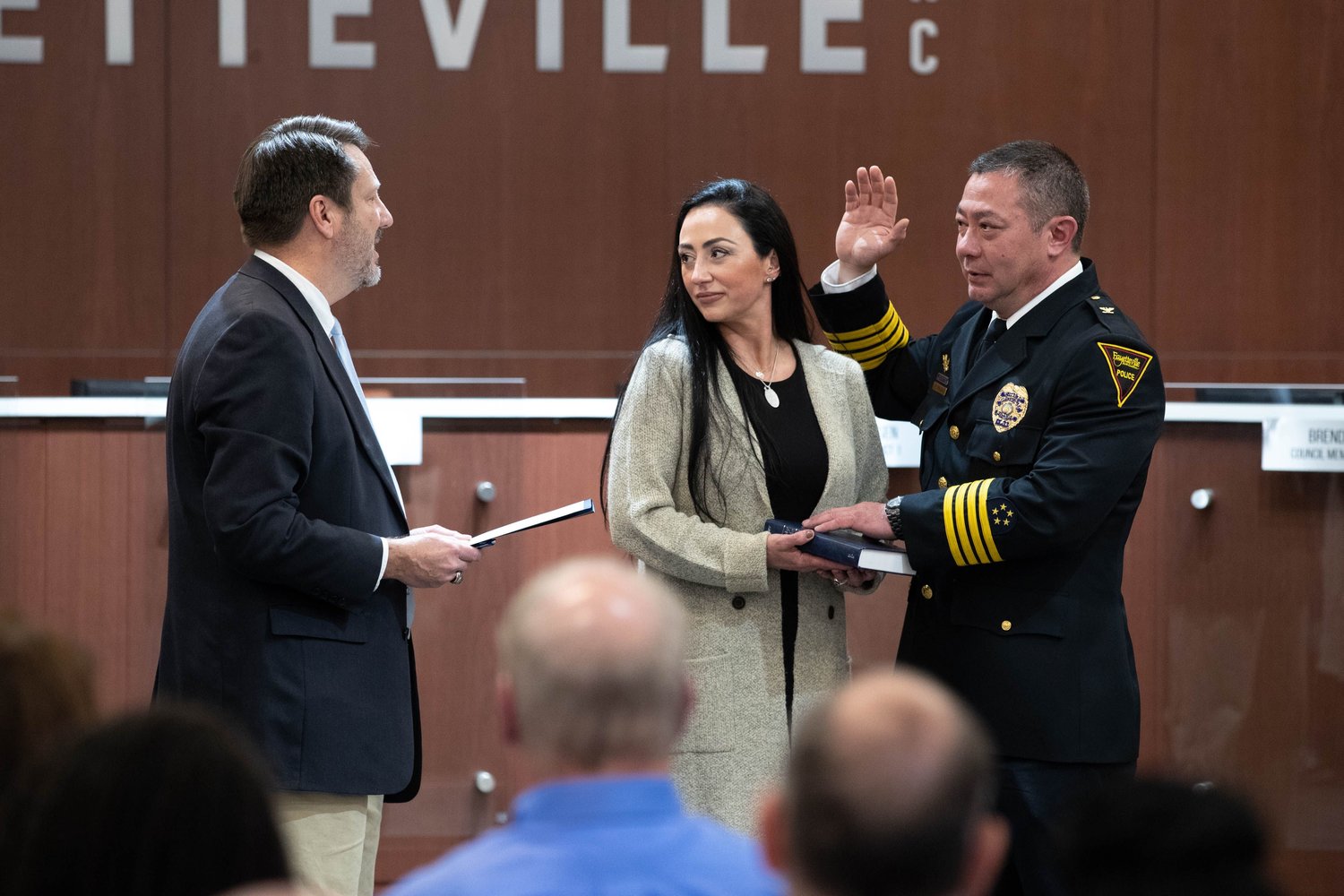 Cumberland County Superior Court Judge Jim Ammons administers the oath of office to Fayetteville Police Chief Kimberle Braden on Friday at City Hall. Holding the Bible is Braden's wife, Beth.