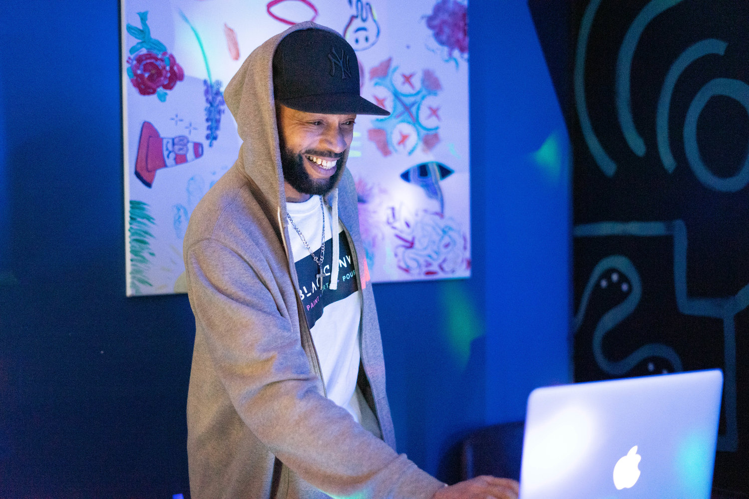 DJ Bernard Mention provides music for Black Canvas' Paint Party.
