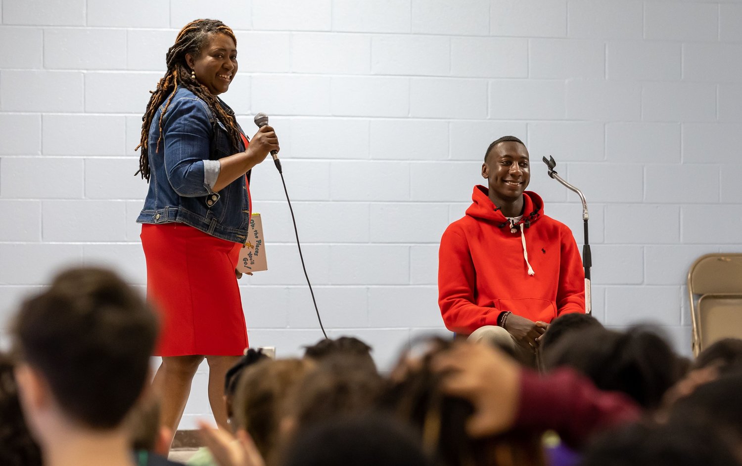 Principal Tara Bratcher introduces Super Bowl champion and Fayetteville native Joshua Williams at Loyd Auman Elementary School on Thursday. Williams read aloud to the children and encouraged them to follow their dreams.