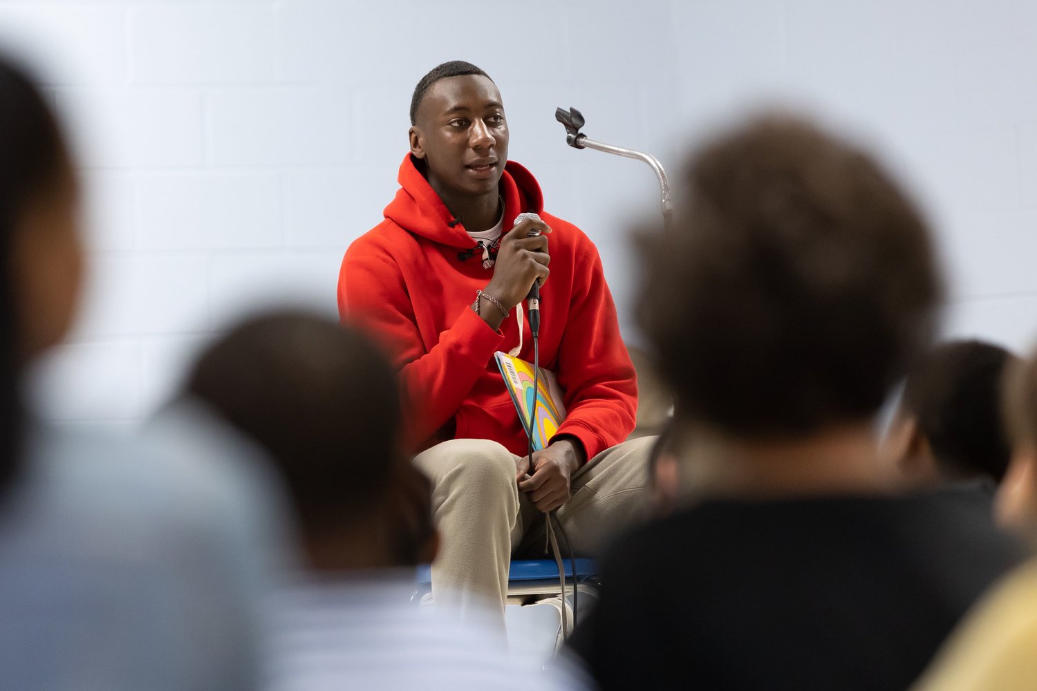 Super Bowl champion and Fayetteville native Joshua Williams speaks to children at Loyd Auman Elementary School on Thursday.