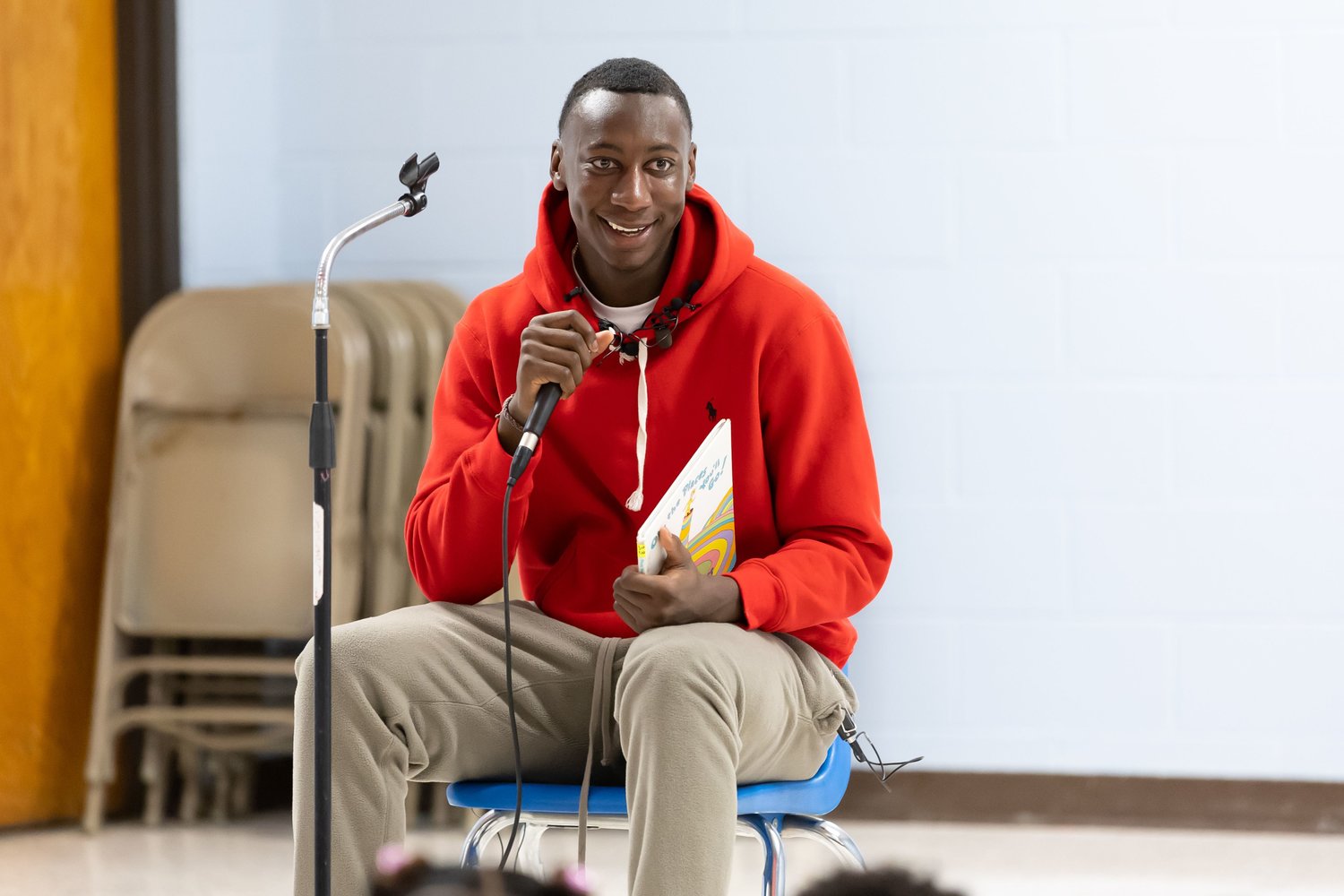 Super Bowl champion and Fayetteville native Joshua Williams gets ready to read a Dr. Seuss book at Loyd Auman Elementary School on Thursday. Williams read aloud to the children and encouraged them to follow their dreams.