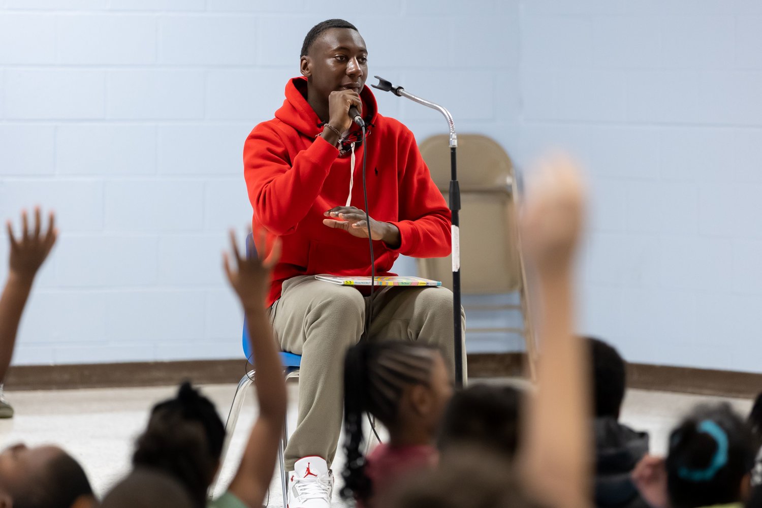 Super Bowl champion and Fayetteville native Joshua Williams speaks to children at Loyd Auman Elementary School on Thursday.