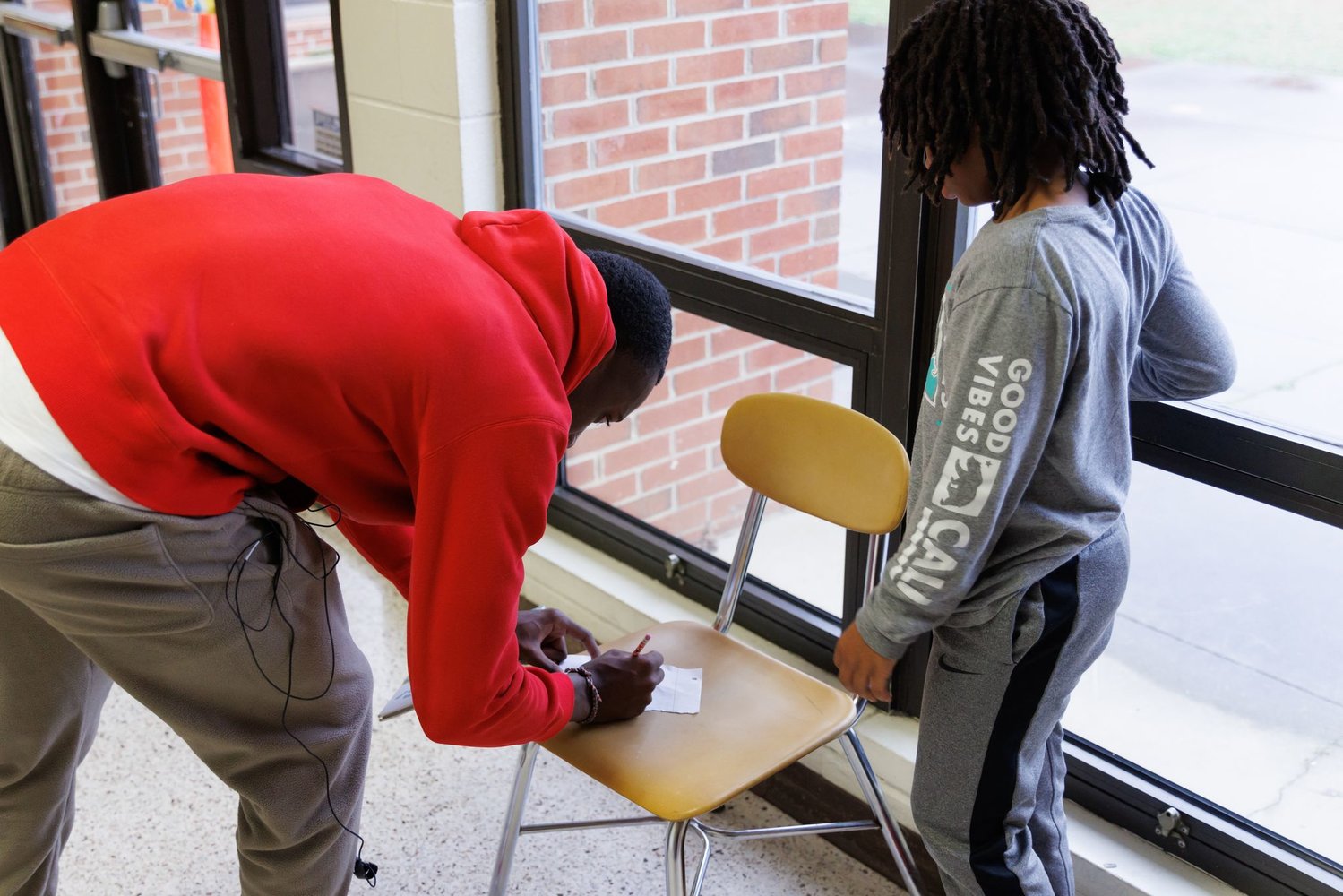 Kansas City Chiefs star and Fayetteville native Joshua Williams signs an autograph for a student at Loyd Auman Elementary School on Thursday. Williams read aloud to the children and encouraged them to follow their dreams.
