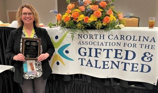 Sarena Myers, the recipient of the NCAGT Outstanding Elementary Teacher of the Gifted Award, proudly displays her plaque.