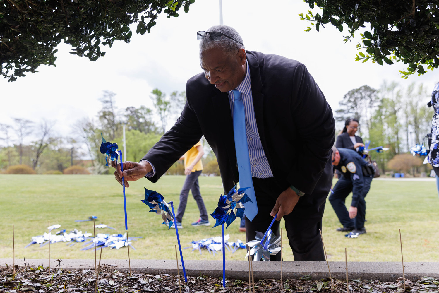 Cumberland County Commissioner Glenn Adams plants a  pinwheel at Festival Park on Friday.