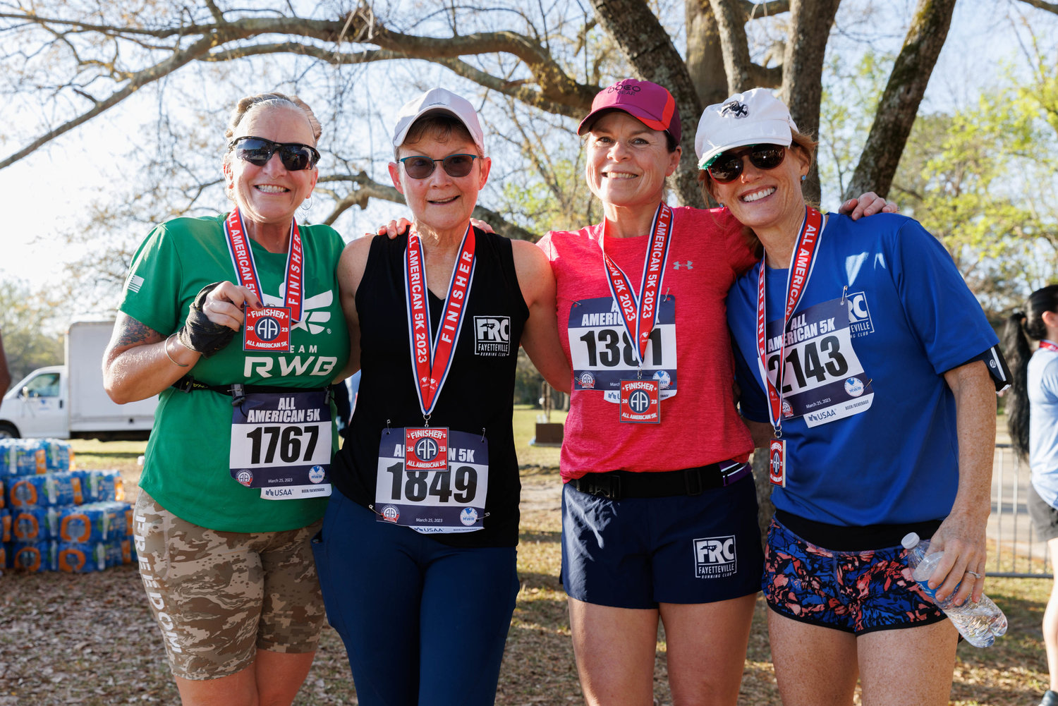 Fayetteville Running Club members Cathy Montes, KJ Powell, Katie Brewer, and Pam Falter pose for a portrait after finishing the All American Race on March 23, 2023.  Tony Wooten/CityView Media