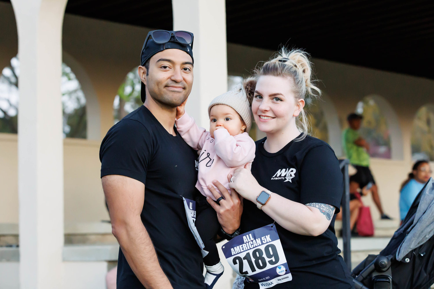 Gio Colon, his wife Whitney Colon, and their daughter Olivia pose for a portrait before the start of the All American Races on  Fort Bragg on March 25, 2023. Tony Wooten/CityView Media