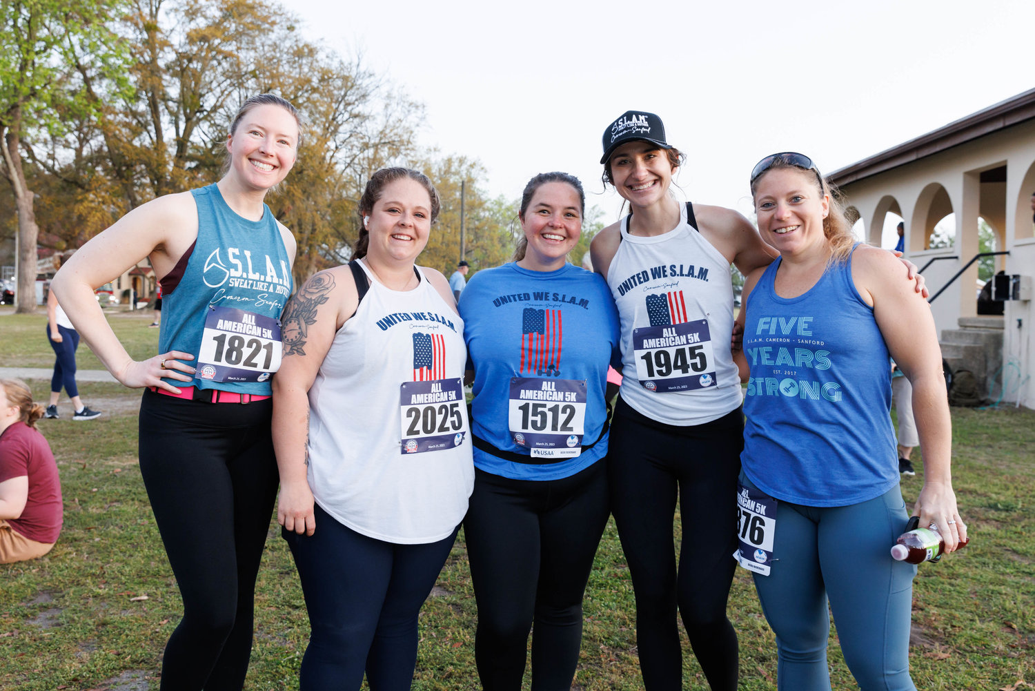Cassandra Perkins, Kelsy Villatora, Meagan Estepp, Sarah Smalley, and Katherine O'Reilly, representing the Cameron/Sanford chapter of Sweat Like a Mother (S.L.A.M.), prepare for the start of the All American Races on  Fort Bragg on March 25, 2023.  Tony Wooten/CityView Media