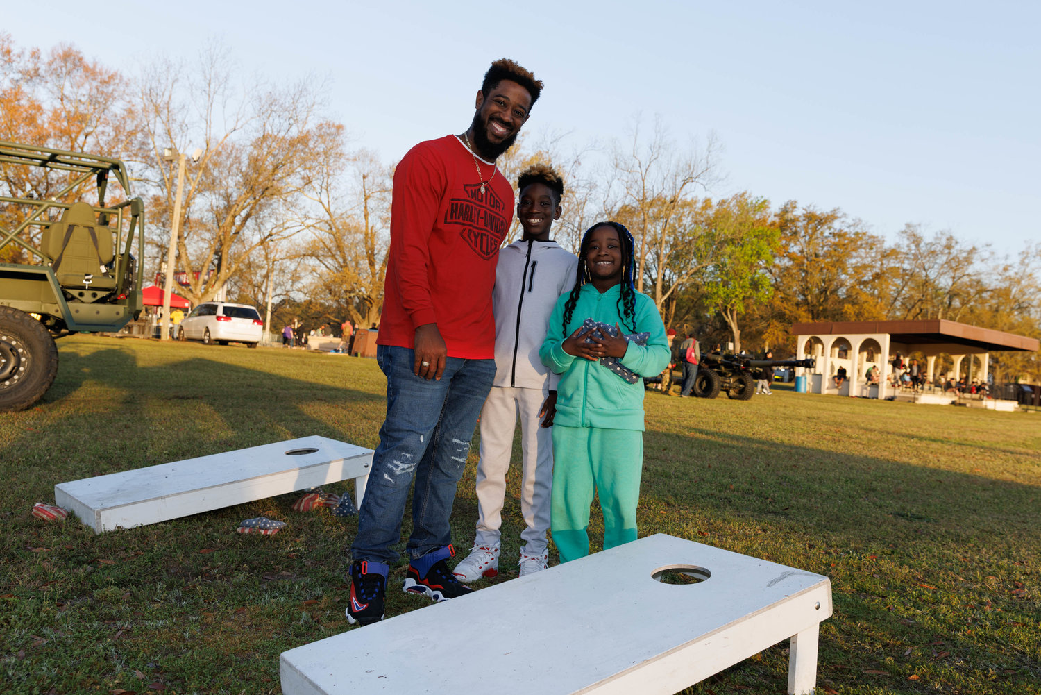 Roger Thompson, Joshua Thompson, and Destiny Thompson pose for a portrait after playing the cornhole setup at the All American Races on Fort Bragg on March 23, 2023.  Tony Wooten/CityView Media