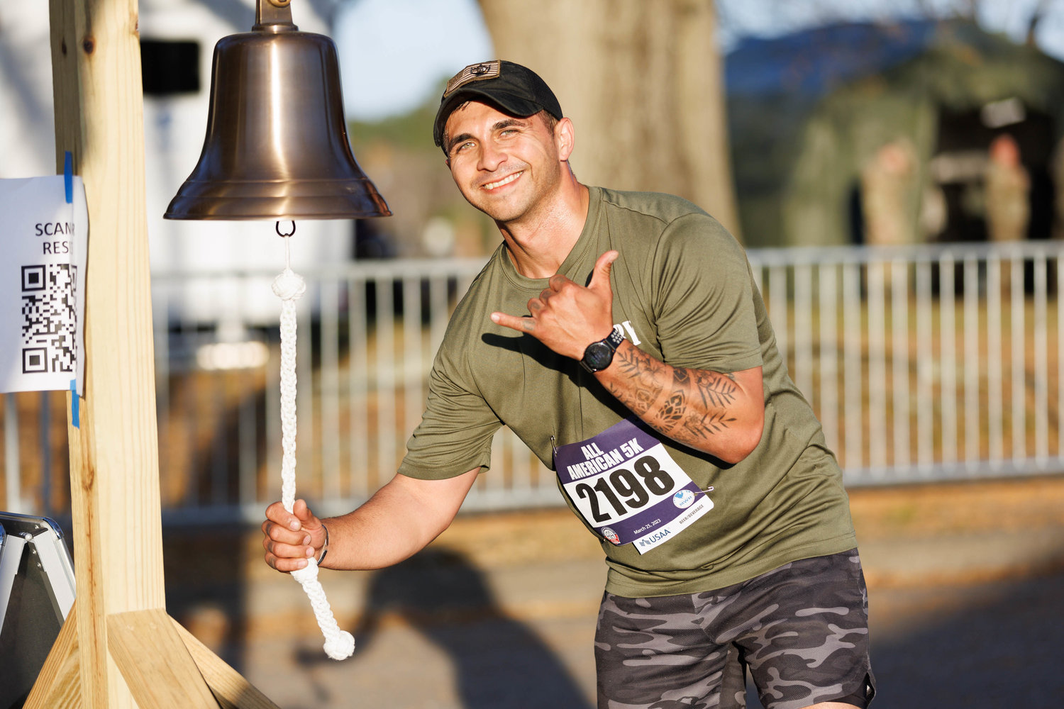 Jon Rickettes rings the bell after completing the All American Race on Fort Bragg on March 23, 2023.  Tony Wooten/CityView Media