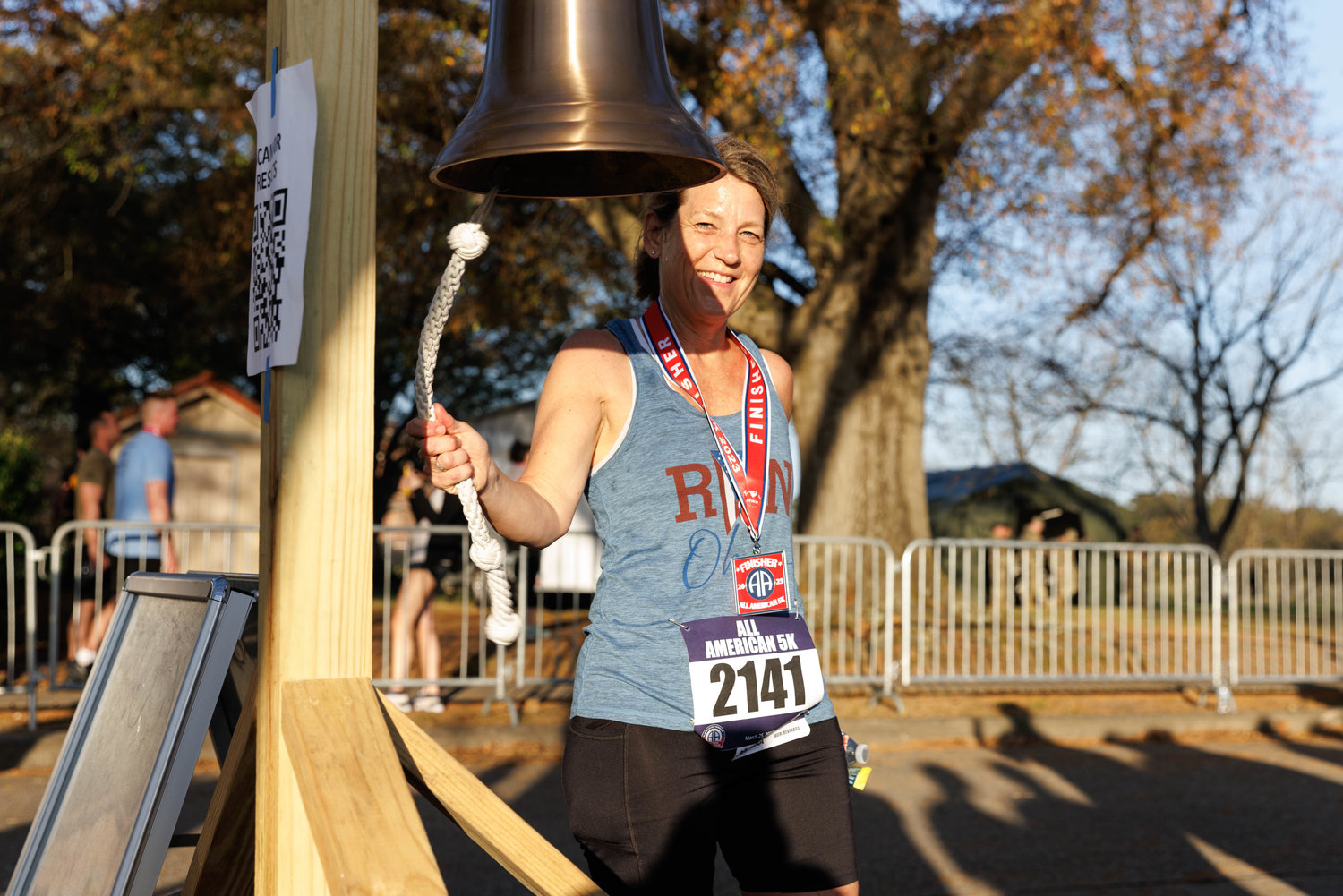 Jennifer Deskins rings the bell after completing the All American Race on Fort Bragg on March 23, 2023.  Tony Wooten/CityView Media