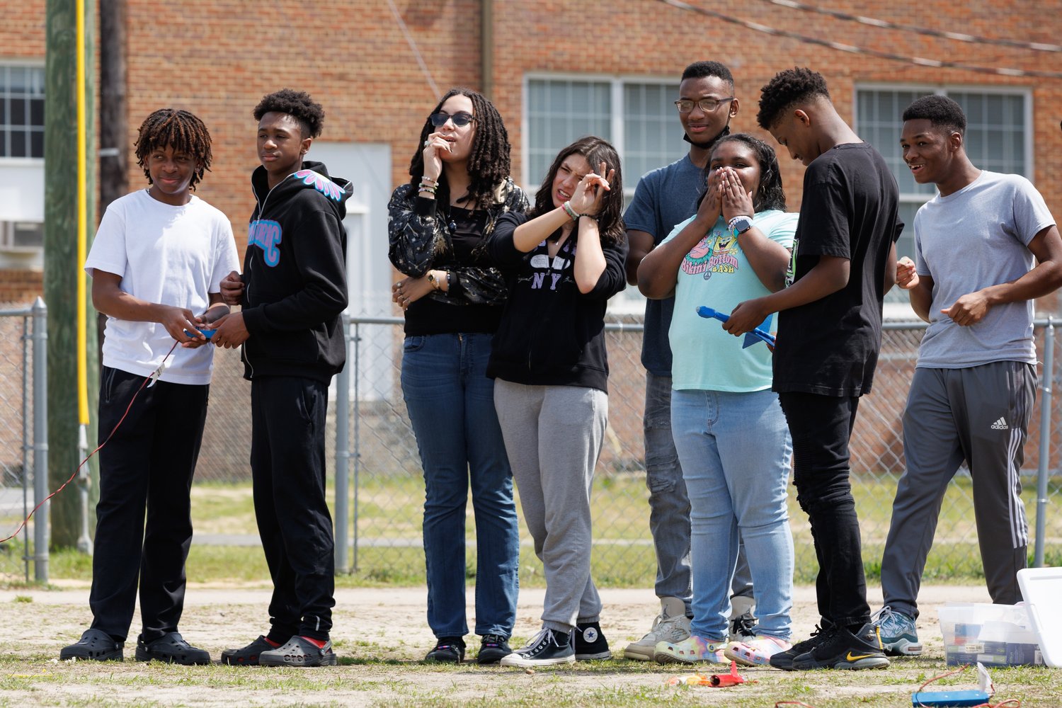Students watch from the sidelines as their rockets are launched at Seventy-First Classical Middle School.