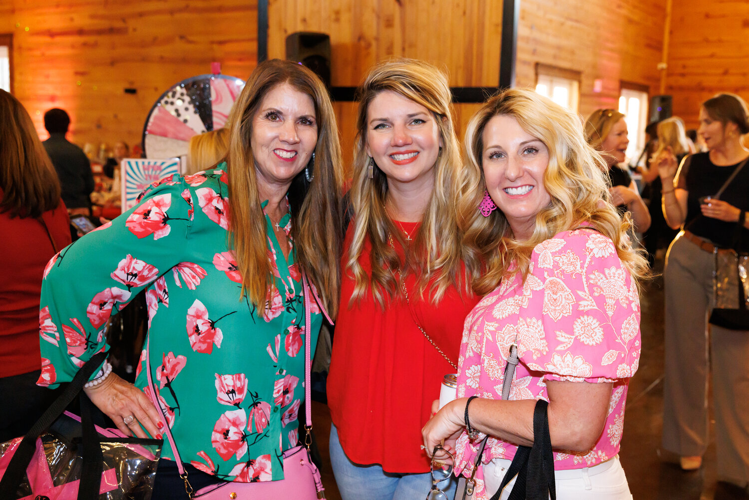 Lisa Bowman, Ashley Ballard, and Sherri Broglin have fun together at Ladies' Night Out.