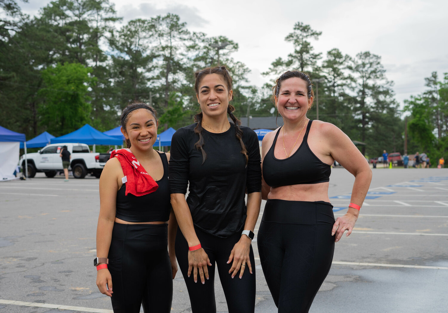 Daisy Betancourt, Jennifer Hanke and Veronica Arnold attend in Fort Bragg's Mud Run.