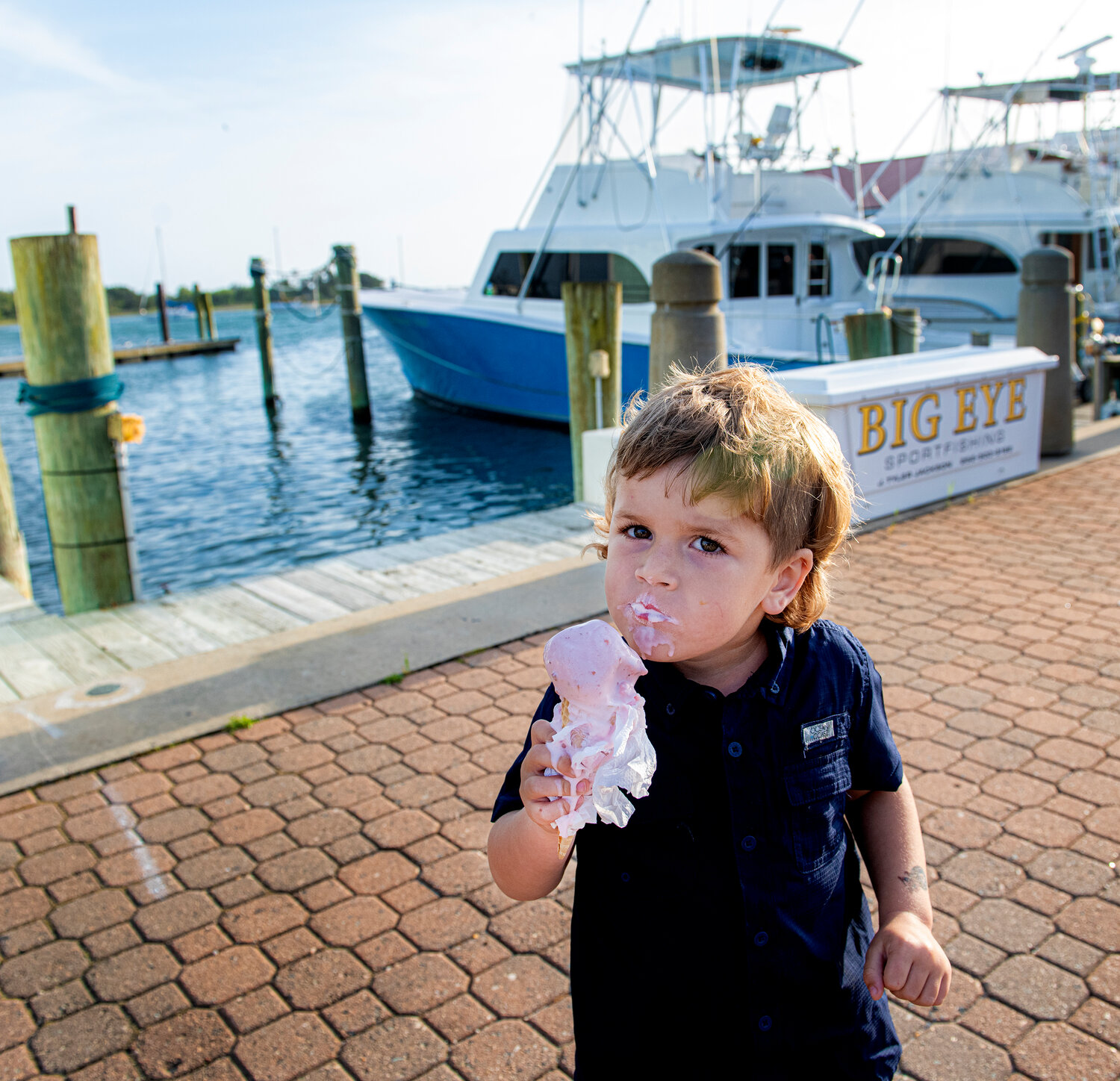 Three-year-old Emerson Roscoe from Goldsboro enjoys his strawberry ice cream at the Morehead City waterfront.