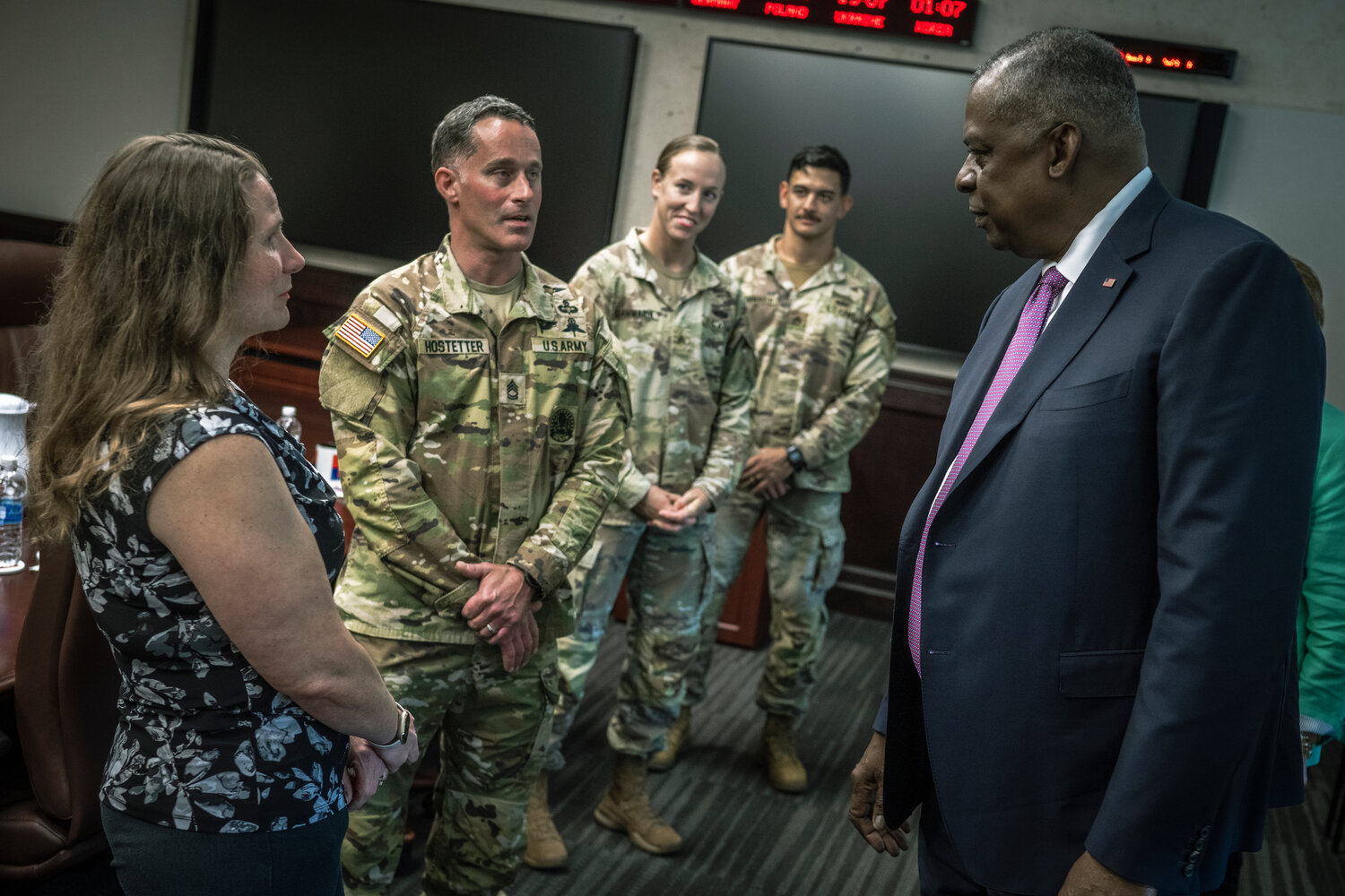 Secretary of Defense Lloyd J. Austin III speaks with Sgt. 1st Class Brian Hostetter and his wife, Robin, during a visit with families assigned to the 82nd Airborne Division at Fort Bragg on Friday.