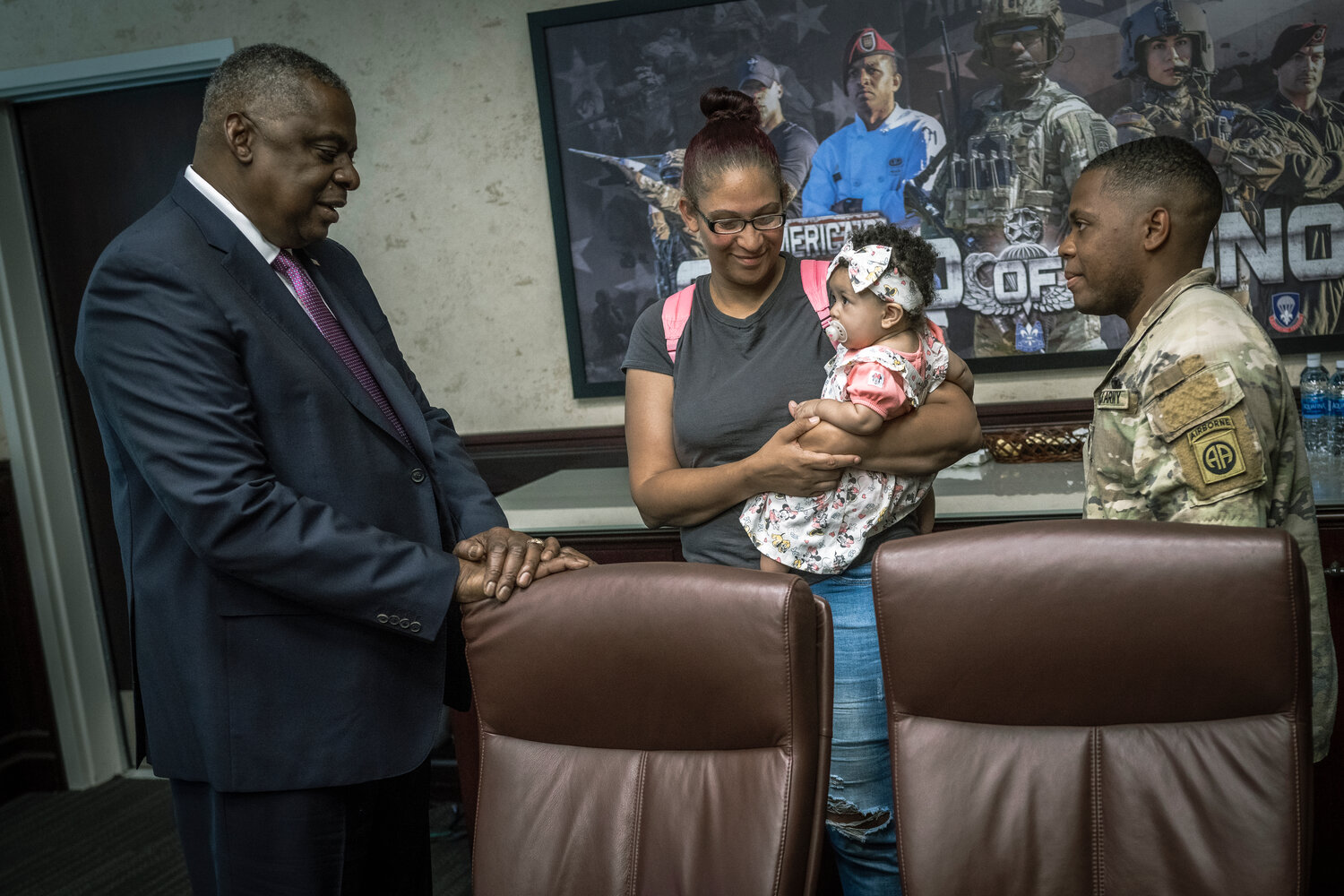 Secretary of Defense Lloyd J. Austin III speaks with Nicole Rosemont and Spc. Delton Wallace during a visit with families assigned to the 82nd Airborne Division on Friday.