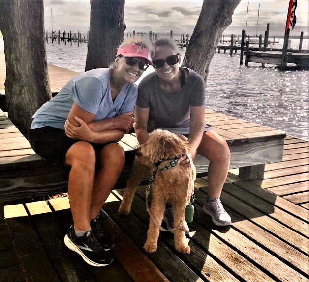 The Monaco twins -- Lisa Monaco Wheeless, left and Margit Monaco Hicks, with Margit’s mini-golden doodle Arleigh -- brought home four girls doubles titles from 1977 to 1980 for Terry Sanford.