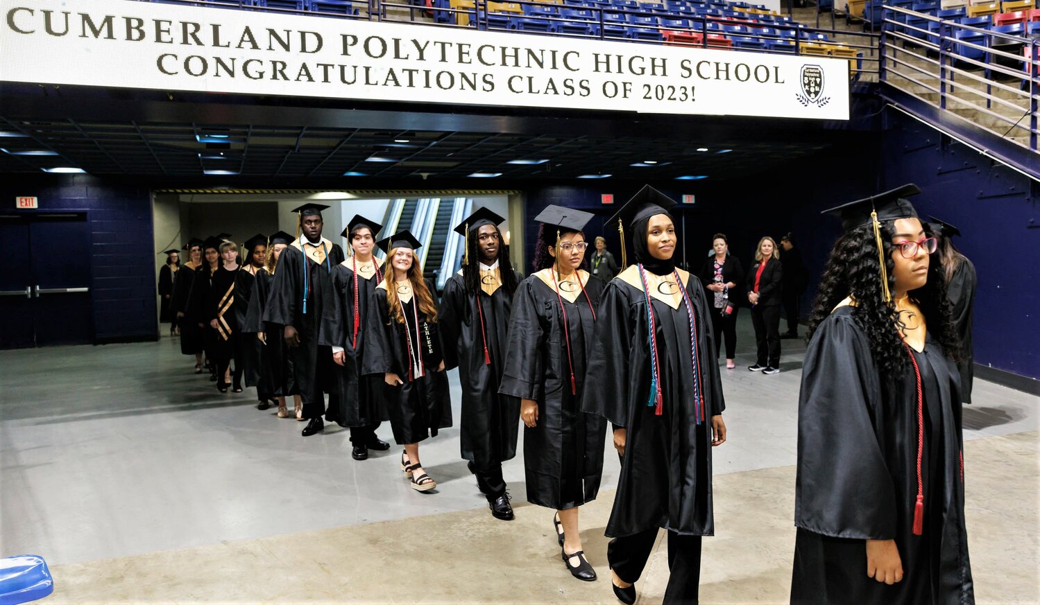Cumberland Polytechnic High School students enter the graduation exercises Thursday at the Crown Coliseum.
