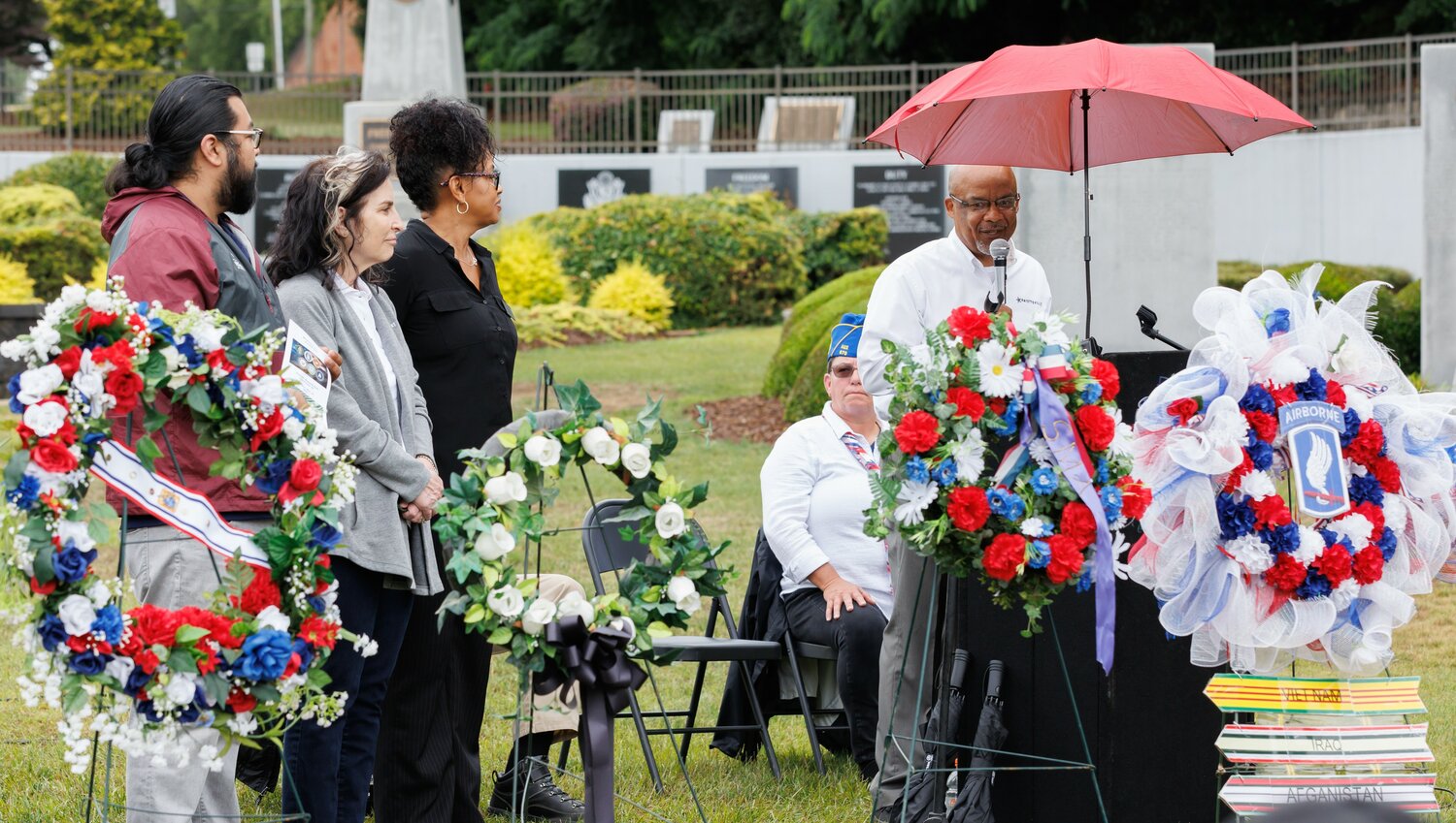 Fayetteville City Council members deliver a city proclamation during the Memorial Day ceremony at Freedom Memorial Park. From left are Mario Benavente, Kathy Jensen, Brenda McNair and Derrick Thompson.