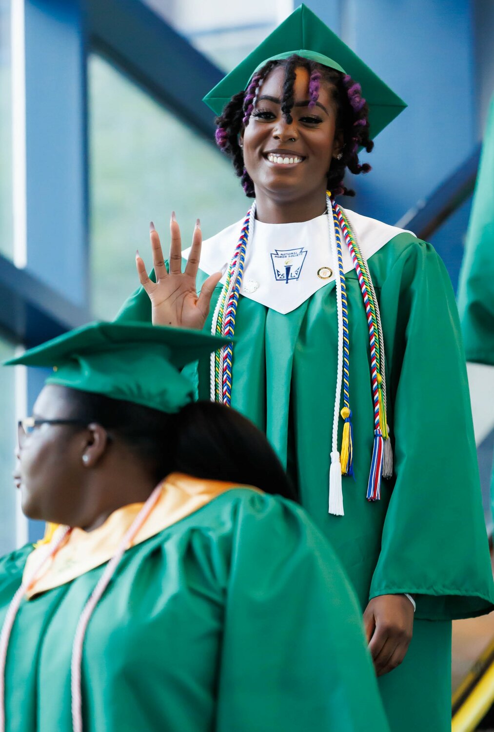 A Pine Forest High School graduate descends the escalator at commencement Monday in the Crown Coliseum.
