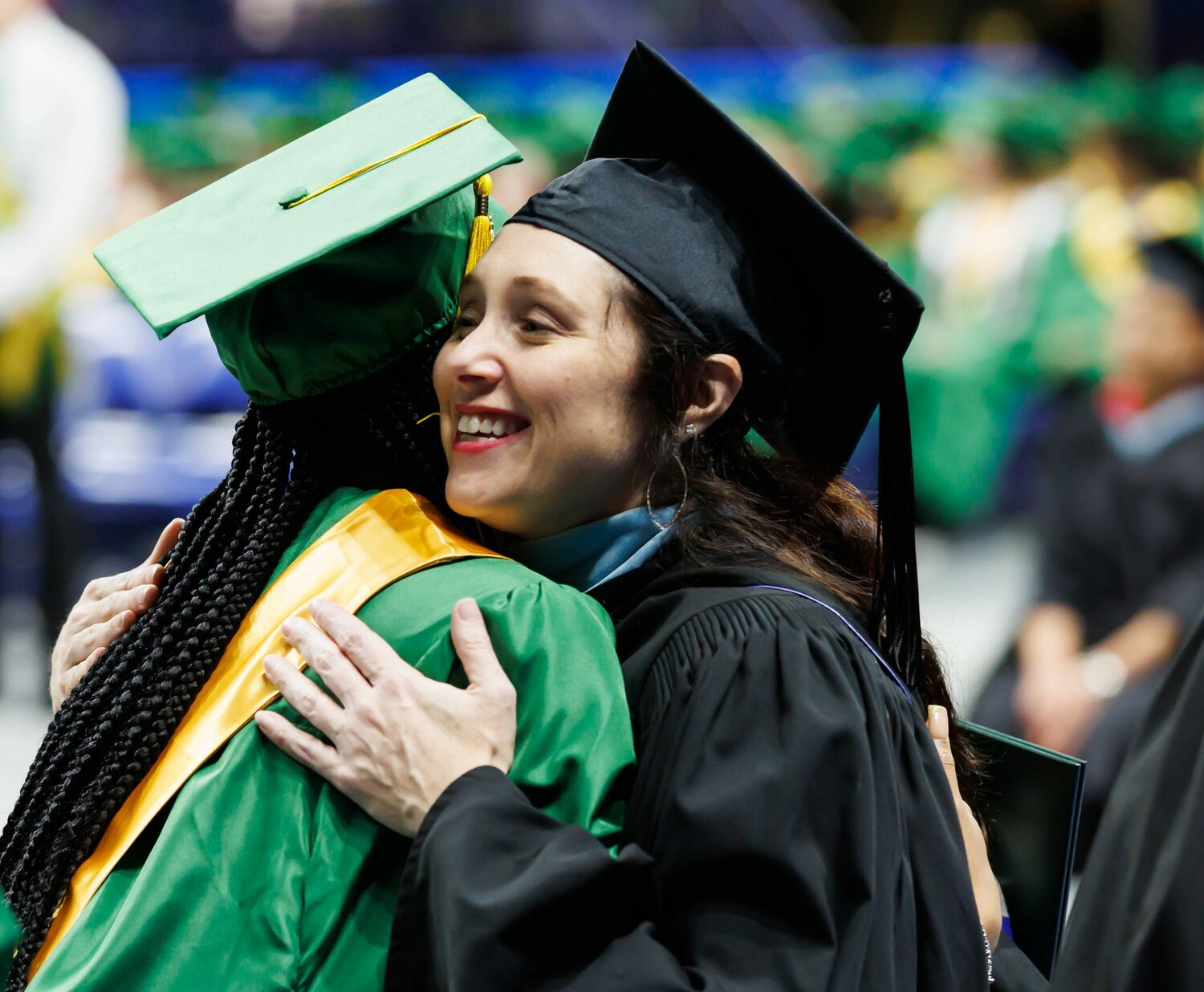 A Pine Forest High School graduate gets a celebratory hug at commencement Monday in the Crown Coliseum.