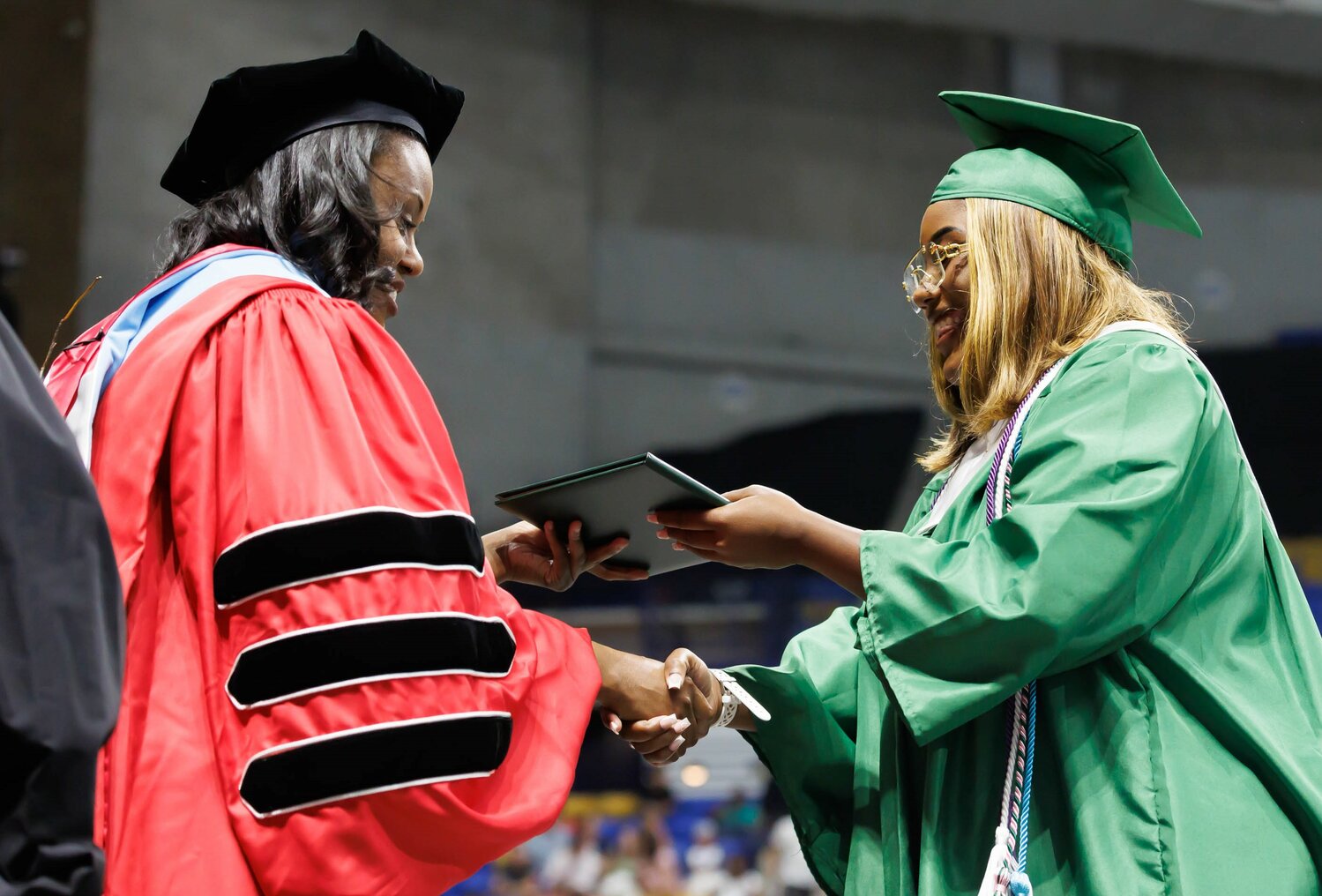 Pine Forest High School principal Juele McDonald hands a diploma to a graduate at commencement Monday in the Crown Coliseum.