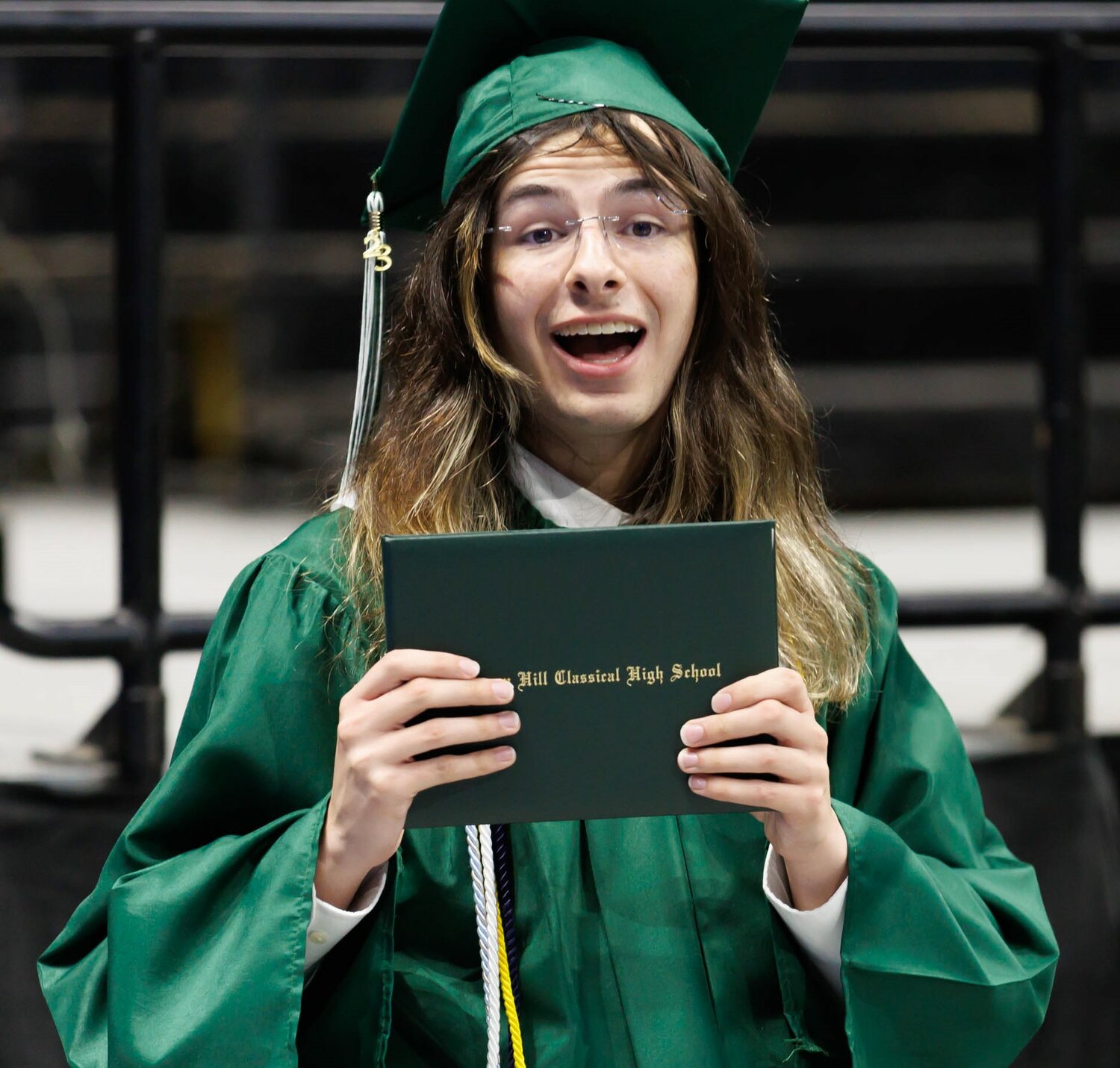 A student shows off his diploma at the 2023 commencement for Massey Hill Classical High School on Tuesday at the Crown Coliseum.
