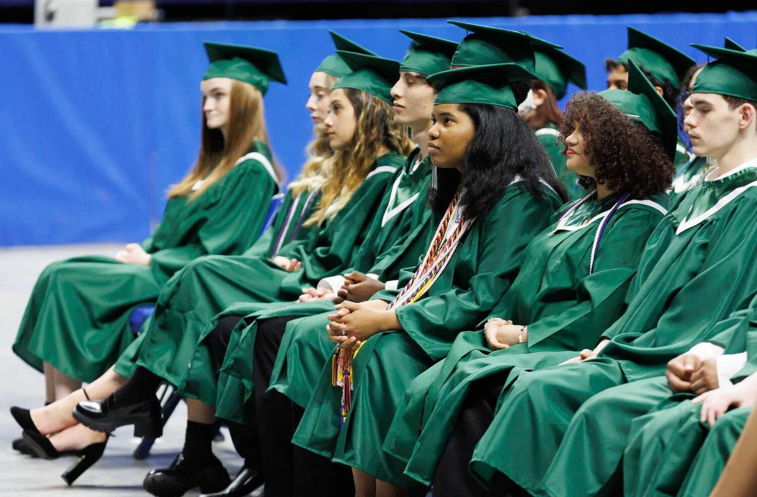 Students listen to the program at the 2023 commencement for Massey Hill Classical High School on Tuesday at the Crown Coliseum.