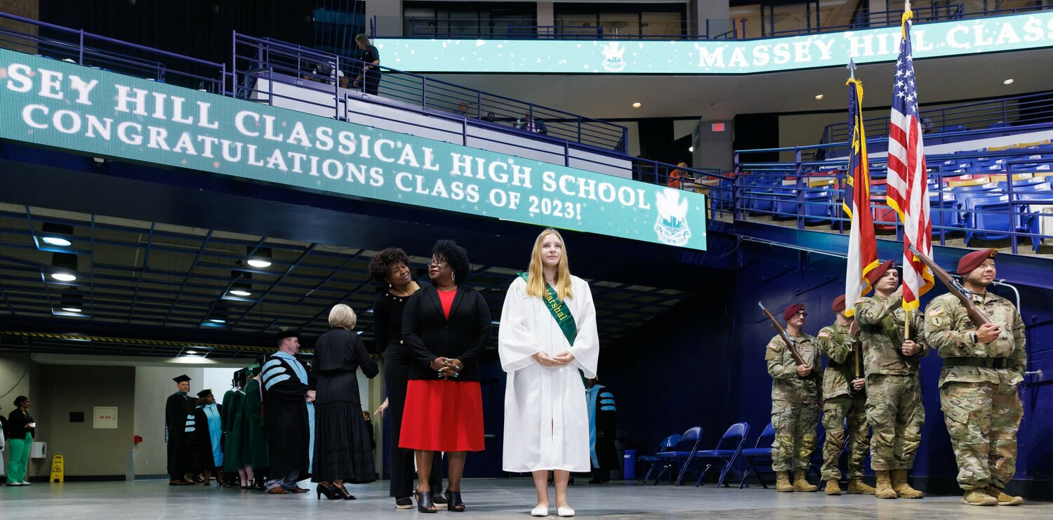 Students file into the Crown Coliseum for the Massey Hill Classical High School 2023 commencement on Tuesday.
