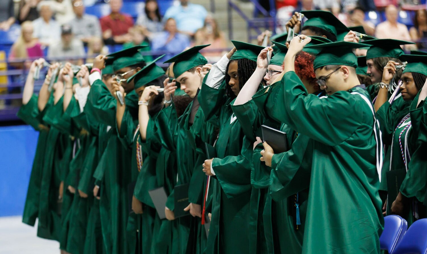 Graduates turn their tassels during the Massey Hill Classical High School 2023 commencement on Tuesday at the Crown Coliseum.