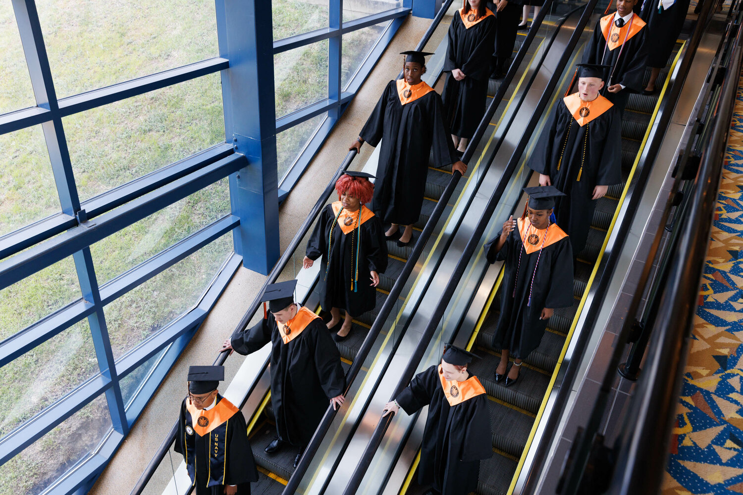 Graduates descend the escalators as South View High School holds its 2023 commencement Tuesday at the Crown Coliseum.