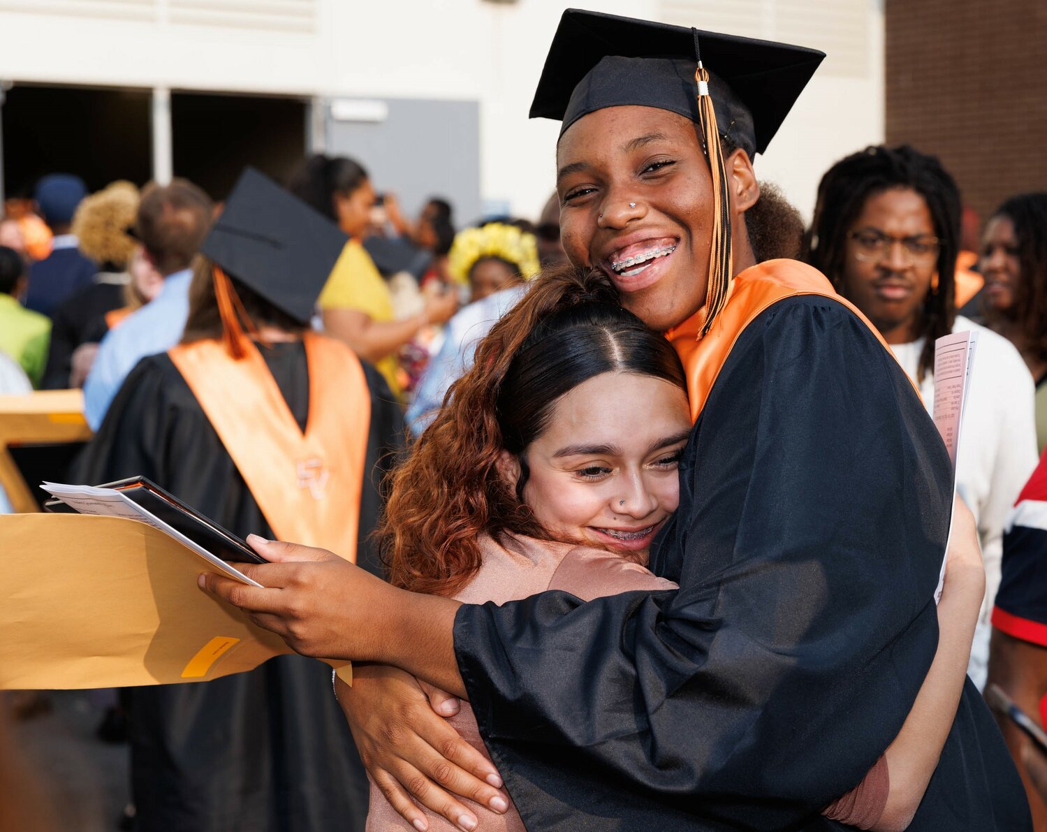 A graduate gets a hug at South View High School's 2023 commencement Tuesday at the Crown Coliseum.