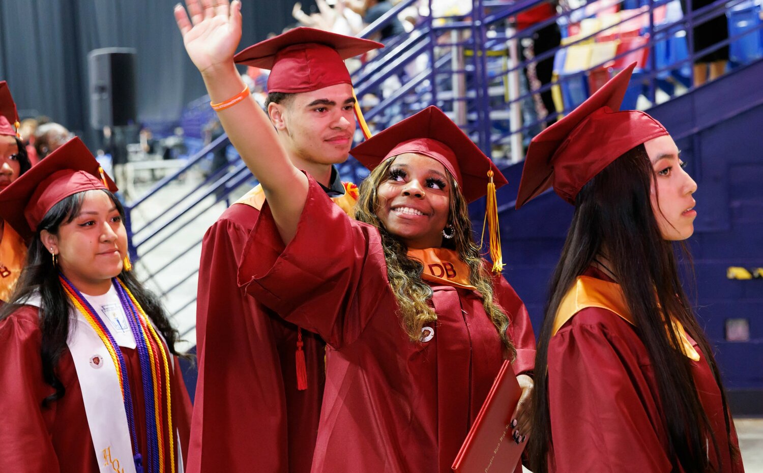 A Douglas Byrd High School graduate spots someone in the crowd during the 2023 commencement Wednesday at the Crown Coliseum.